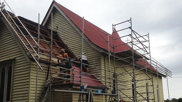 garden city roofing team doing roo repairs on red house - roofing toowoomba