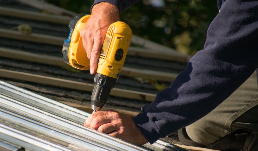 Roofer Repairing A Storm-damaged Roof